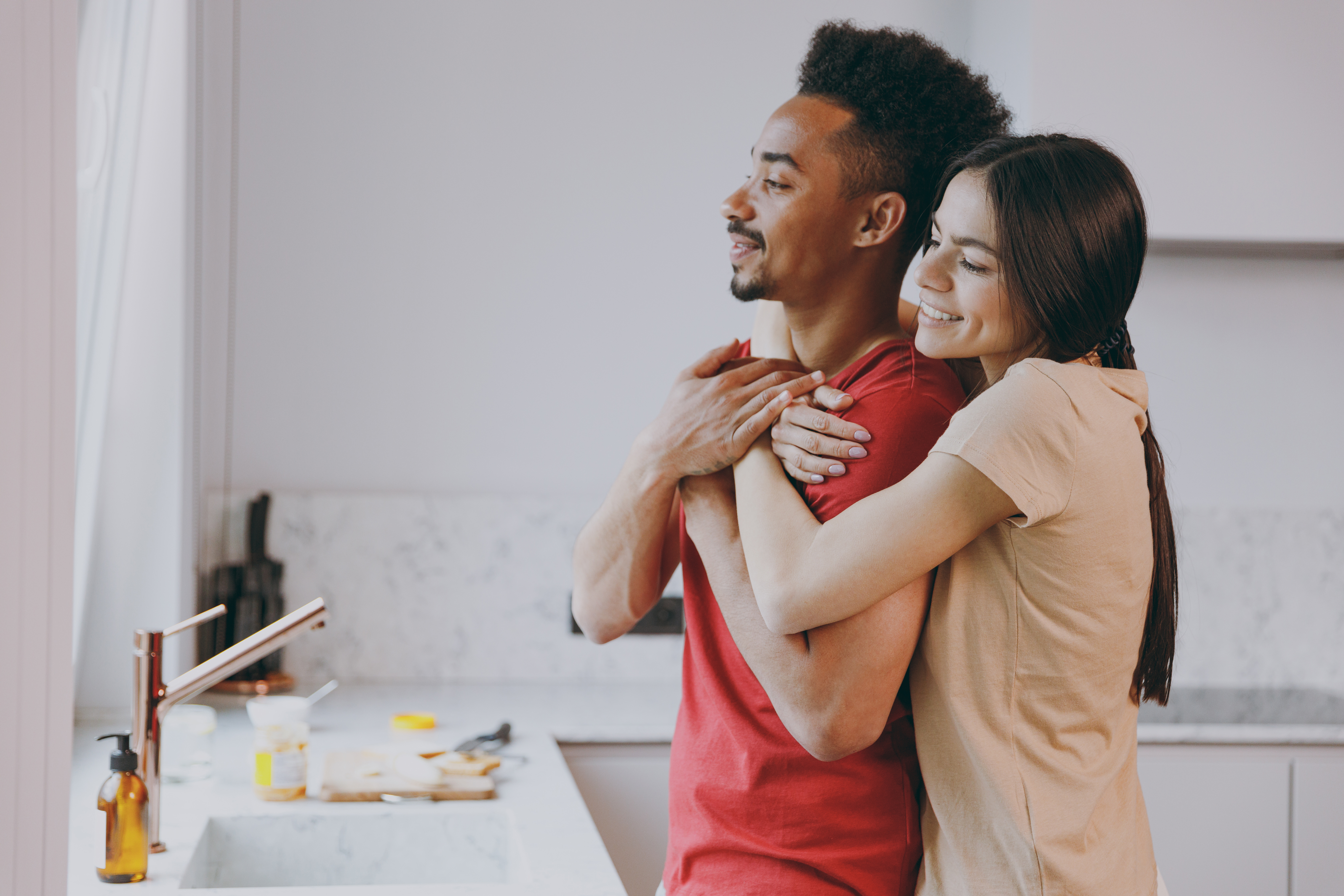 Two people sitting on the grass and laughing